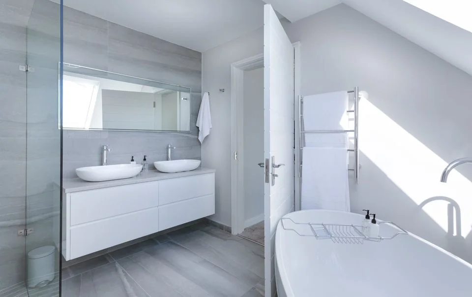 Bathroom with a double vanity, freestanding bath and glass shower